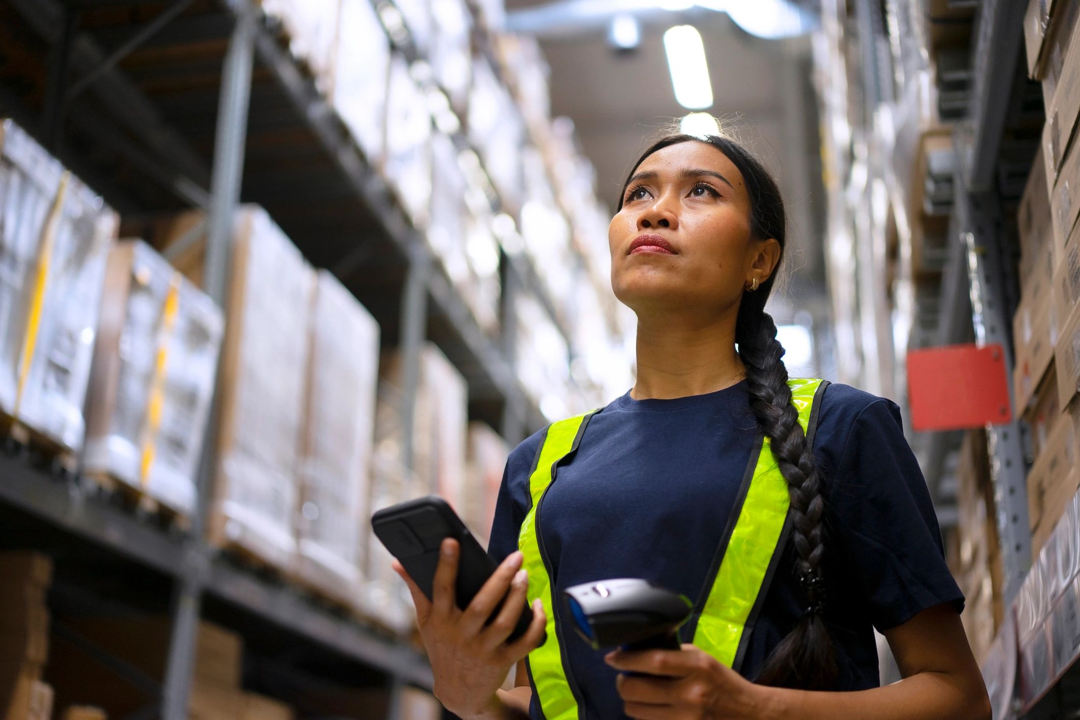 Warehouse employee checking merchandise with a clipboard
