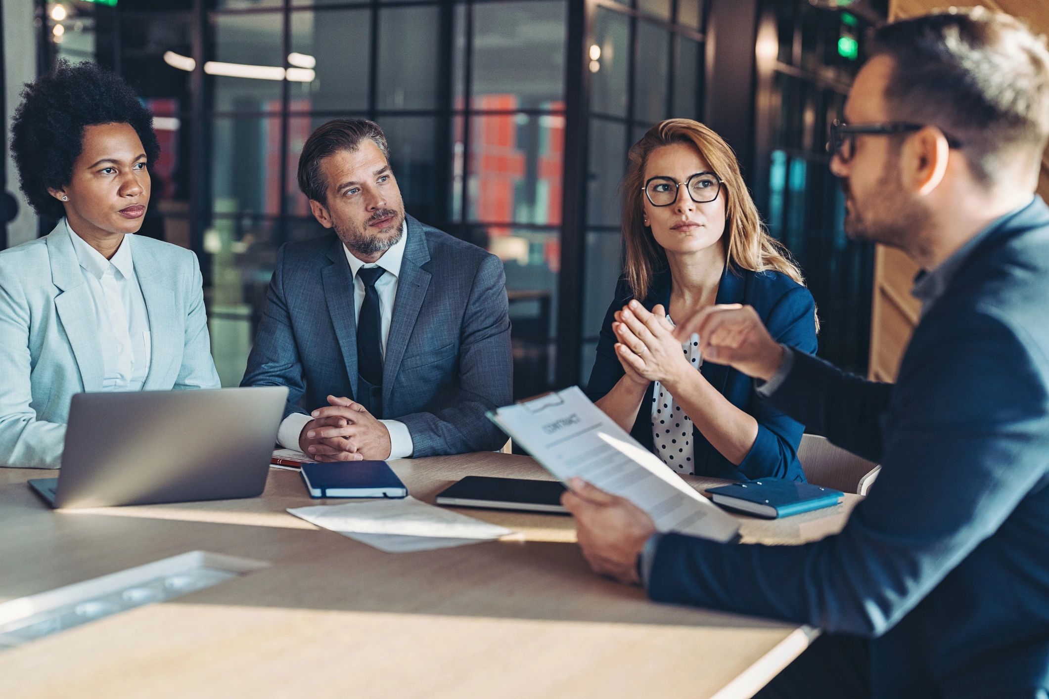 Procurement professionals reviewing documents in a meeting