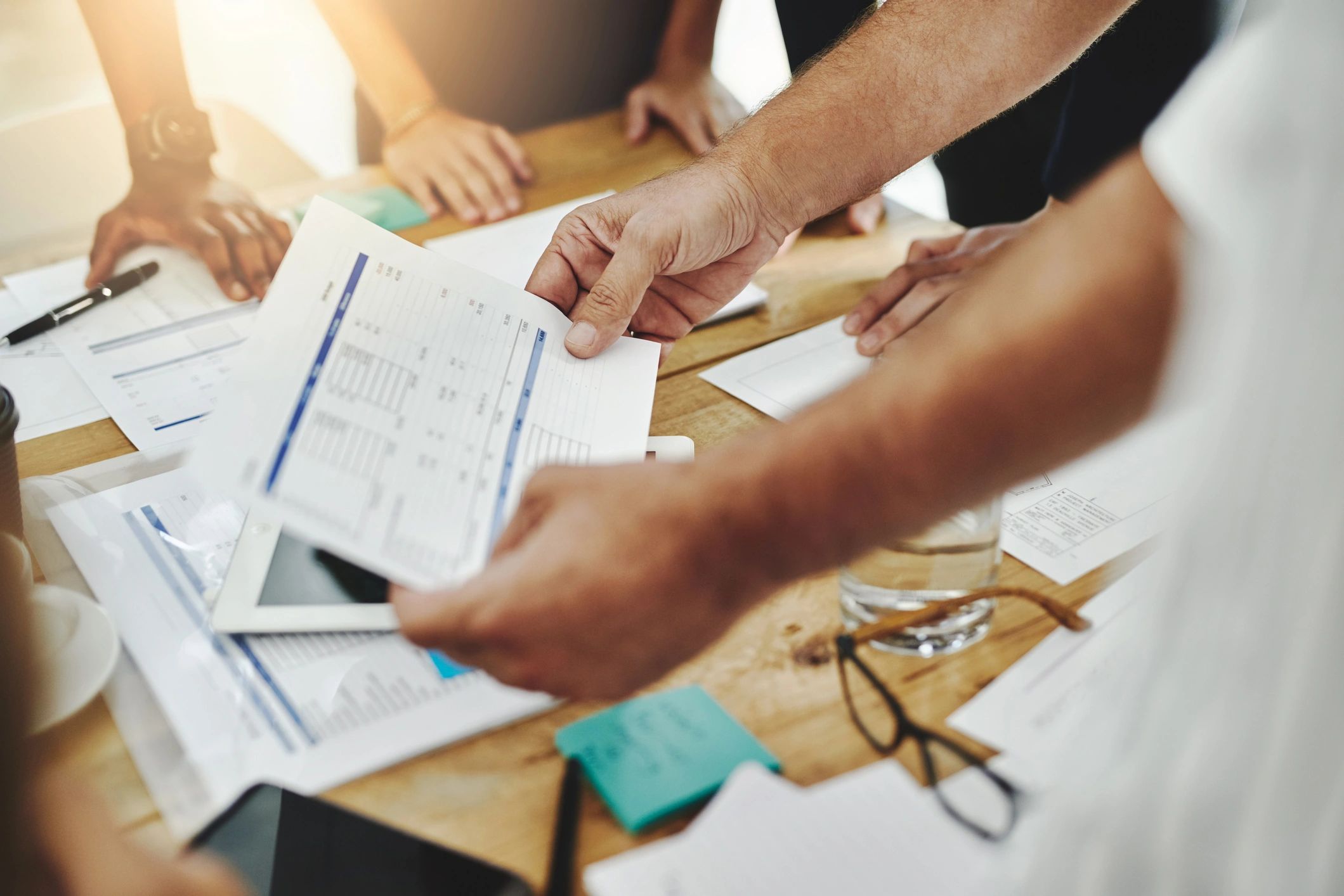 Procurement team reviewing documents and performance metrics in an office