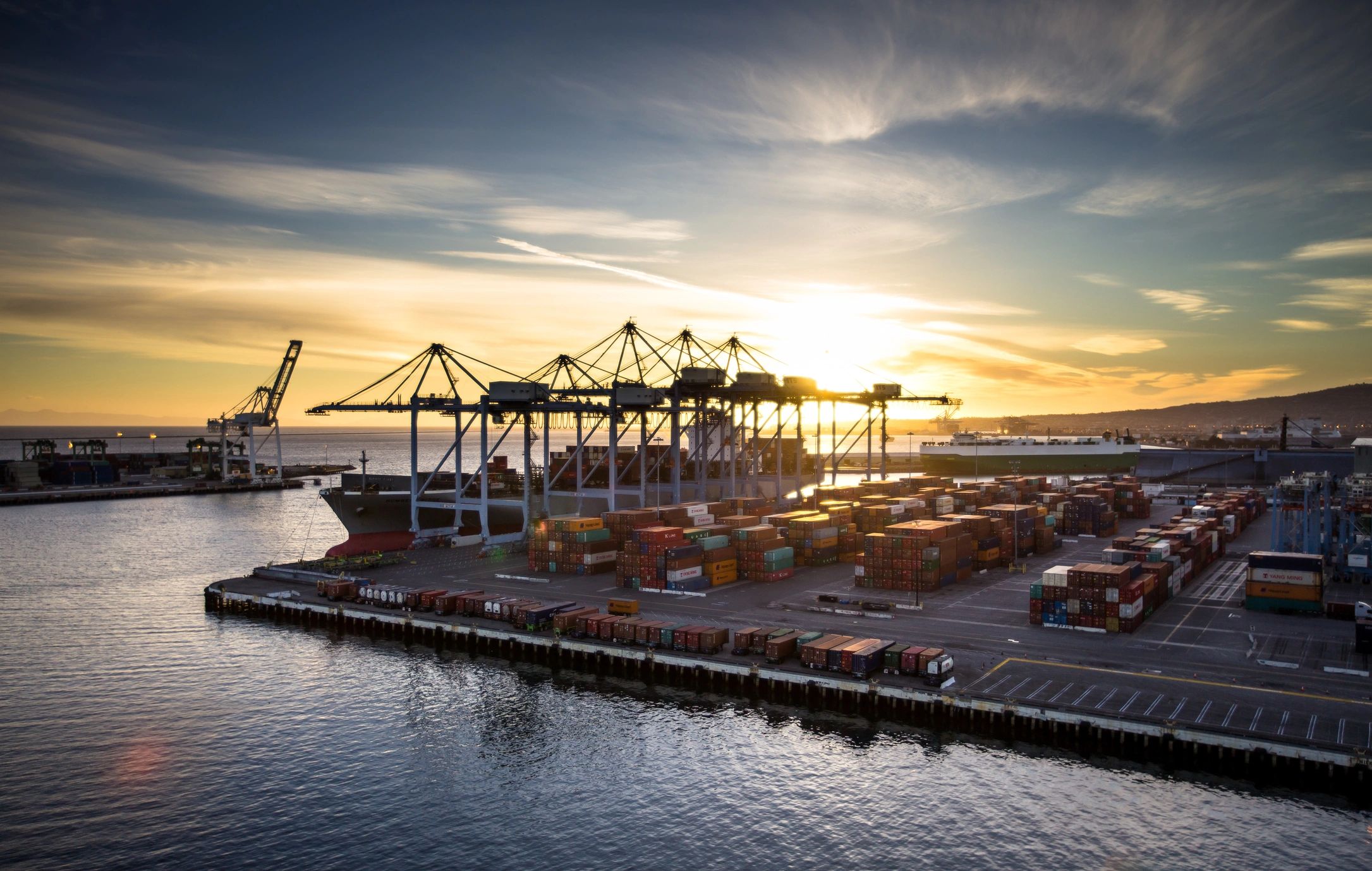 Container terminal with stacked shipping containers at a global port